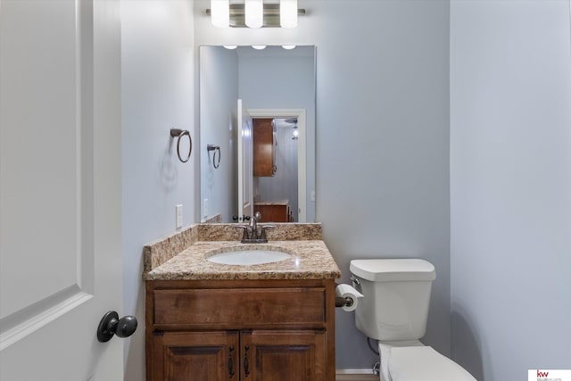 bathroom with toilet and vanity