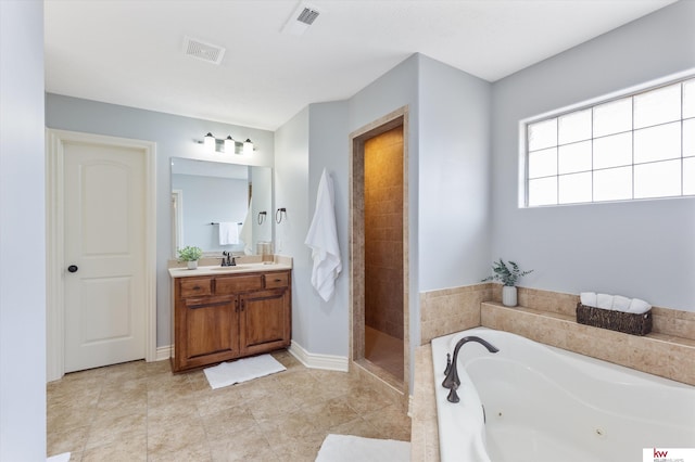 bathroom featuring a jetted tub, a stall shower, visible vents, and vanity