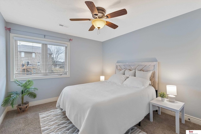 carpeted bedroom featuring baseboards, visible vents, and ceiling fan