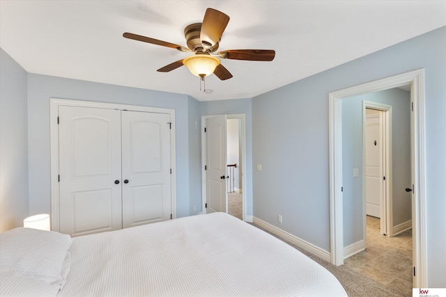 bedroom featuring ceiling fan, a closet, and baseboards