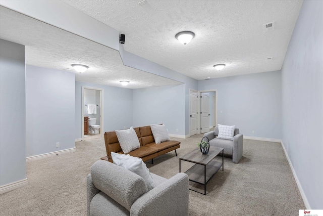 living room featuring carpet, visible vents, a textured ceiling, and baseboards