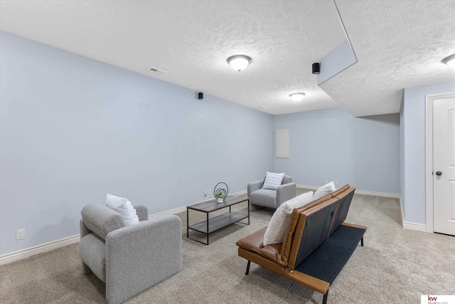 carpeted living room with baseboards, visible vents, and a textured ceiling