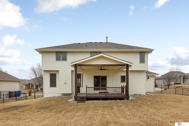 back of property with a ceiling fan, a fenced backyard, a yard, and a wooden deck