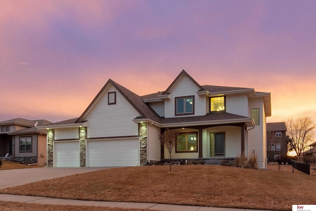 view of front of home featuring a porch, a garage, fence, stone siding, and driveway