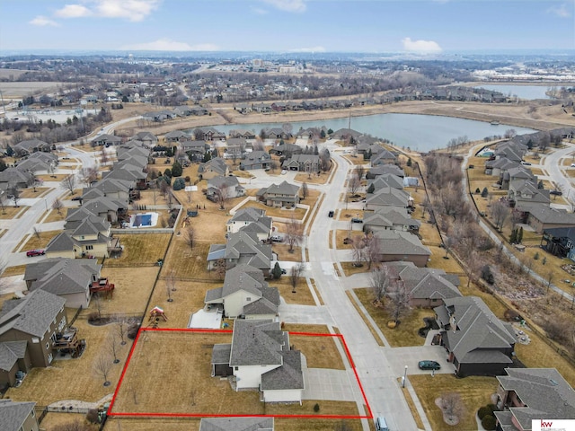 bird's eye view featuring a water view and a residential view