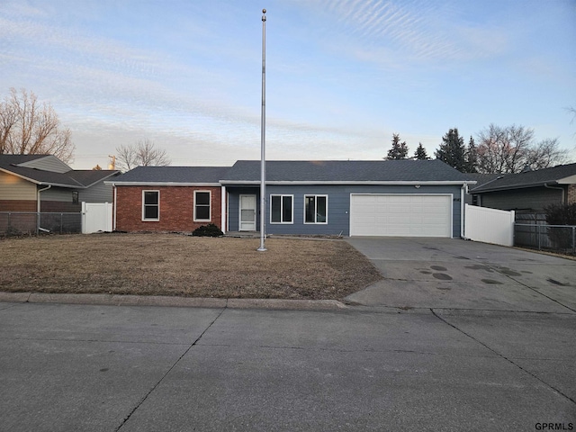 single story home featuring driveway, an attached garage, fence, and brick siding