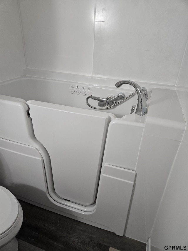 bathroom featuring toilet and wood finished floors