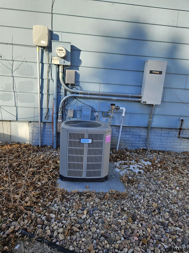 exterior details featuring electric meter and central AC unit