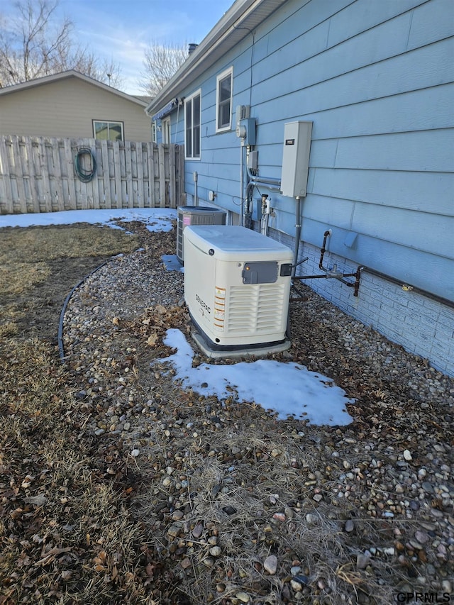 exterior details with central AC, fence, a power unit, and electric meter