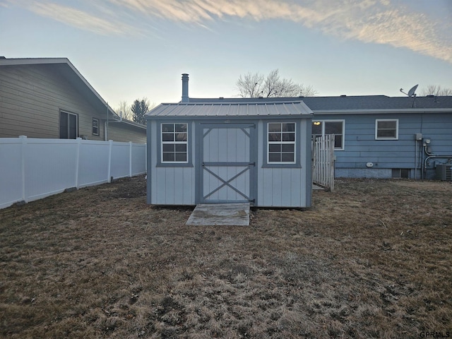 view of shed with fence