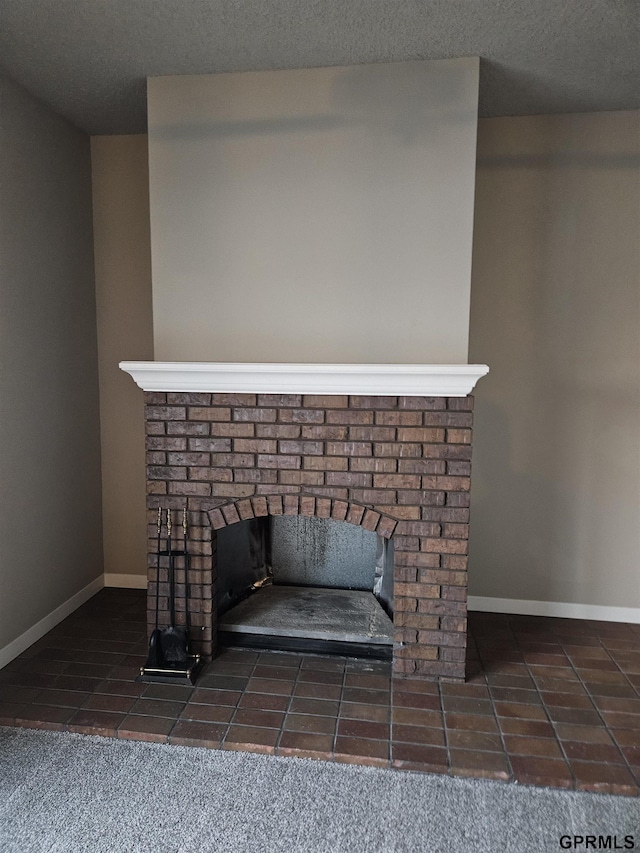 details with a textured ceiling, a fireplace, and baseboards