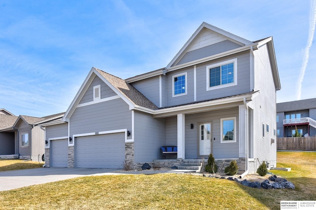 view of front facade with stone siding, driveway, and a front yard