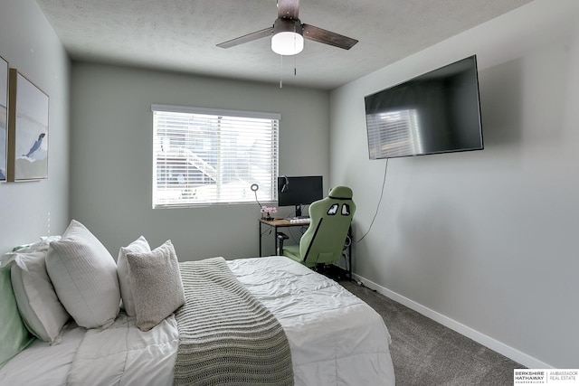 carpeted bedroom featuring ceiling fan, baseboards, and a textured ceiling