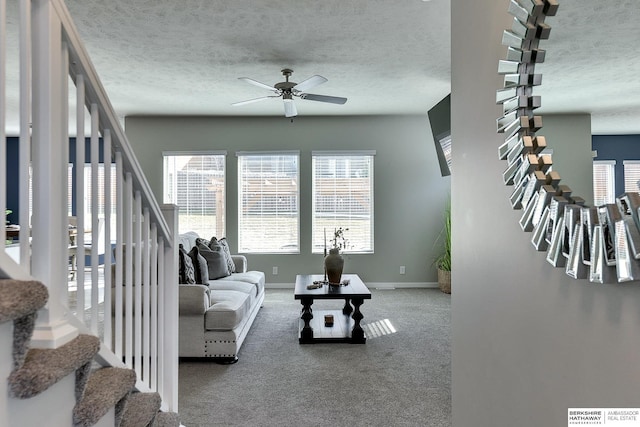 living area featuring stairs and plenty of natural light