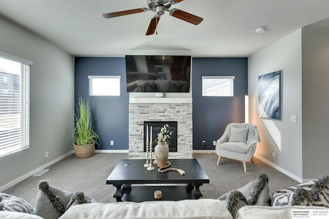 living room featuring visible vents, a ceiling fan, carpet, a fireplace, and baseboards