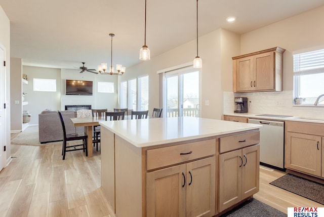 kitchen featuring light wood finished floors, tasteful backsplash, a healthy amount of sunlight, light brown cabinets, and dishwasher