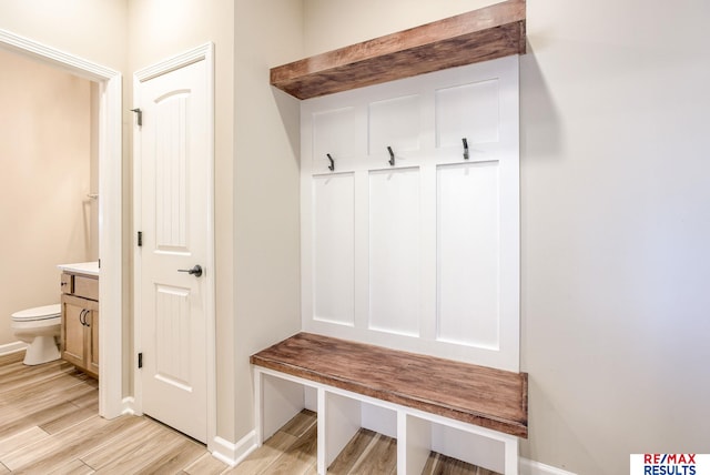 mudroom with light wood-style flooring and baseboards