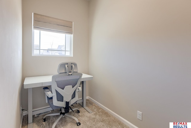 carpeted home office with baseboards