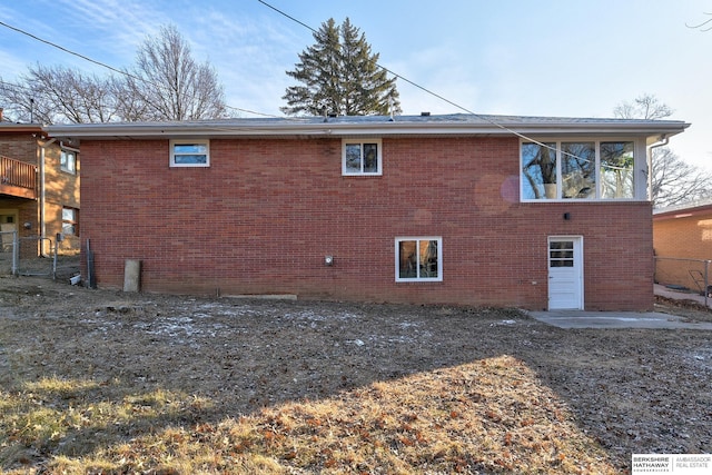 view of home's exterior featuring fence and brick siding