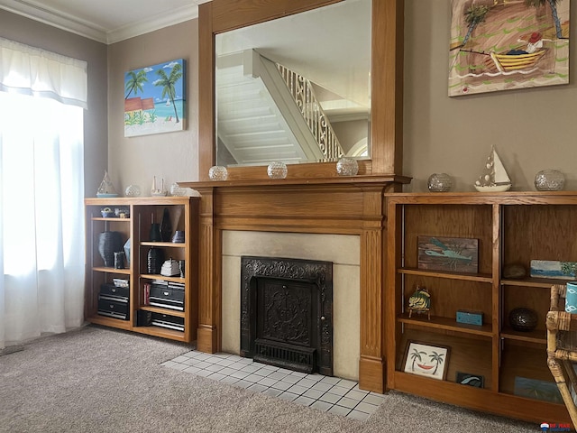 living area with a healthy amount of sunlight, carpet floors, a fireplace with flush hearth, and ornamental molding