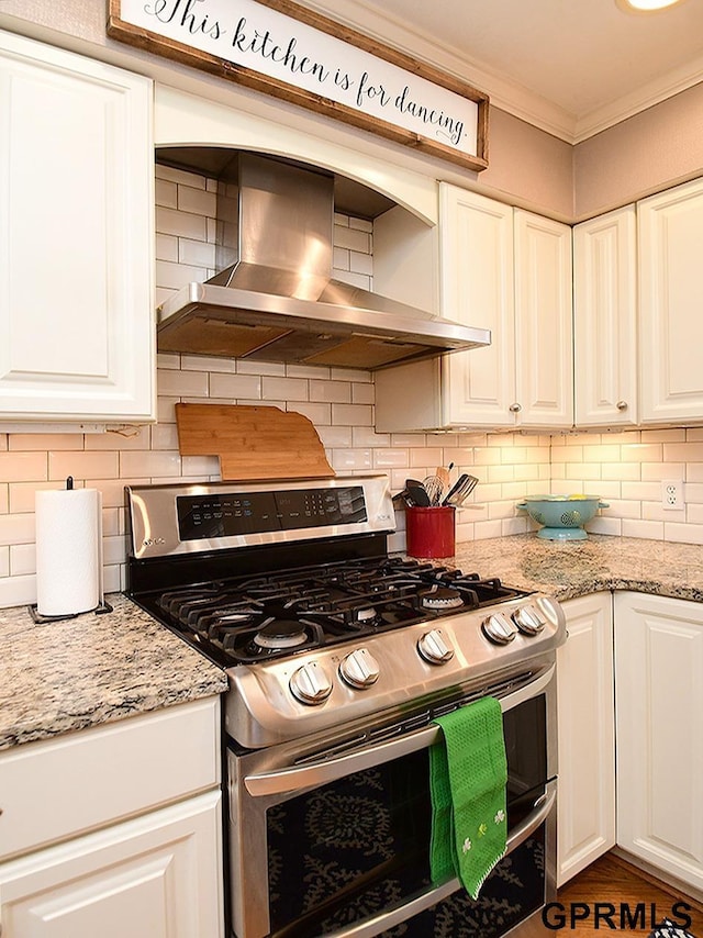 kitchen featuring ornamental molding, white cabinets, double oven range, and wall chimney exhaust hood