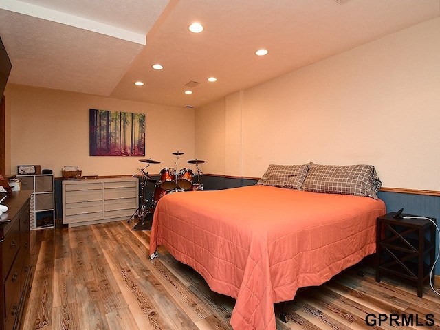 bedroom with wood finished floors and recessed lighting