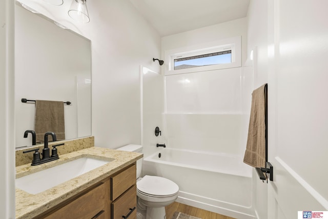 full bathroom with wood finished floors, shower / washtub combination, vanity, and toilet