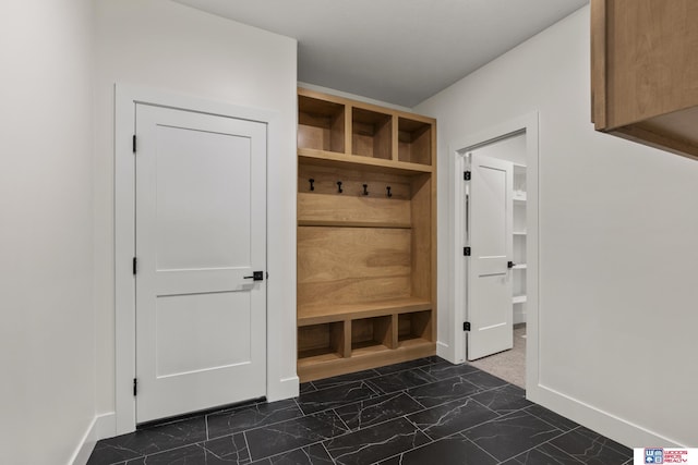 mudroom featuring marble finish floor and baseboards