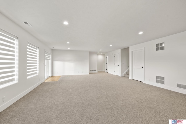 unfurnished room with light carpet and visible vents