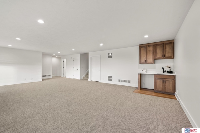 interior space with recessed lighting, visible vents, light carpet, and stairs