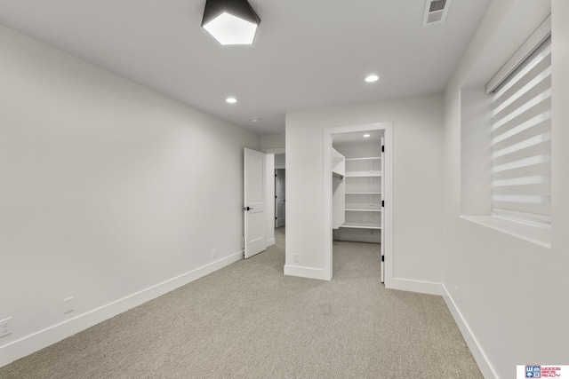 interior space featuring recessed lighting, baseboards, visible vents, and light colored carpet