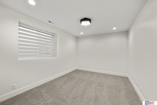 carpeted spare room featuring recessed lighting, visible vents, and baseboards