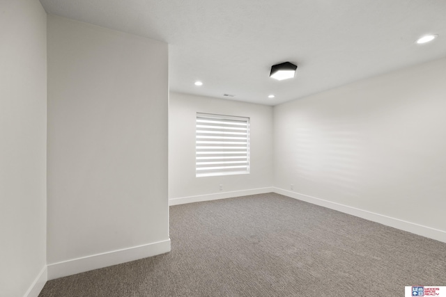 empty room with recessed lighting, dark carpet, and baseboards