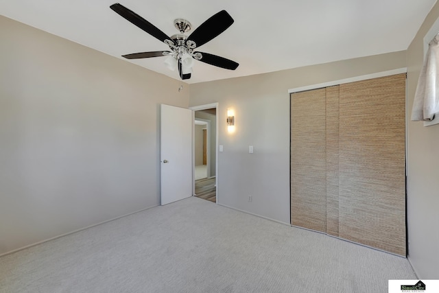 unfurnished bedroom featuring a closet, carpet flooring, and ceiling fan