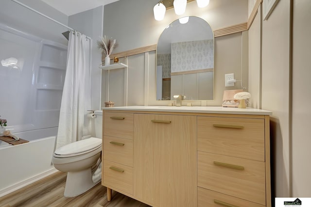 full bath with vanity, shower / tub combo, wood finished floors, and toilet