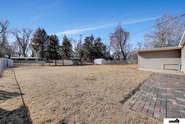 view of yard with a fenced backyard and an outbuilding