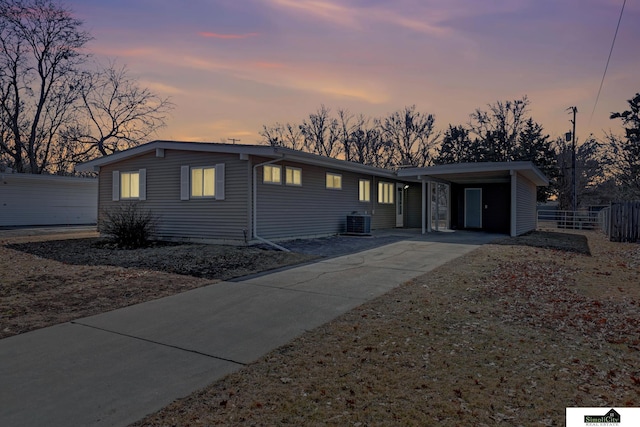 mid-century inspired home featuring fence and central AC