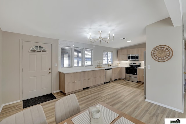 kitchen with modern cabinets, appliances with stainless steel finishes, and light brown cabinetry