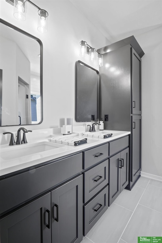 bathroom featuring double vanity, tile patterned flooring, and a sink