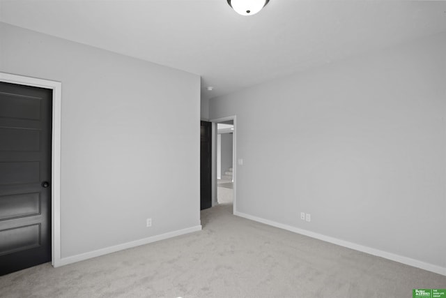 unfurnished bedroom with carpet floors and baseboards