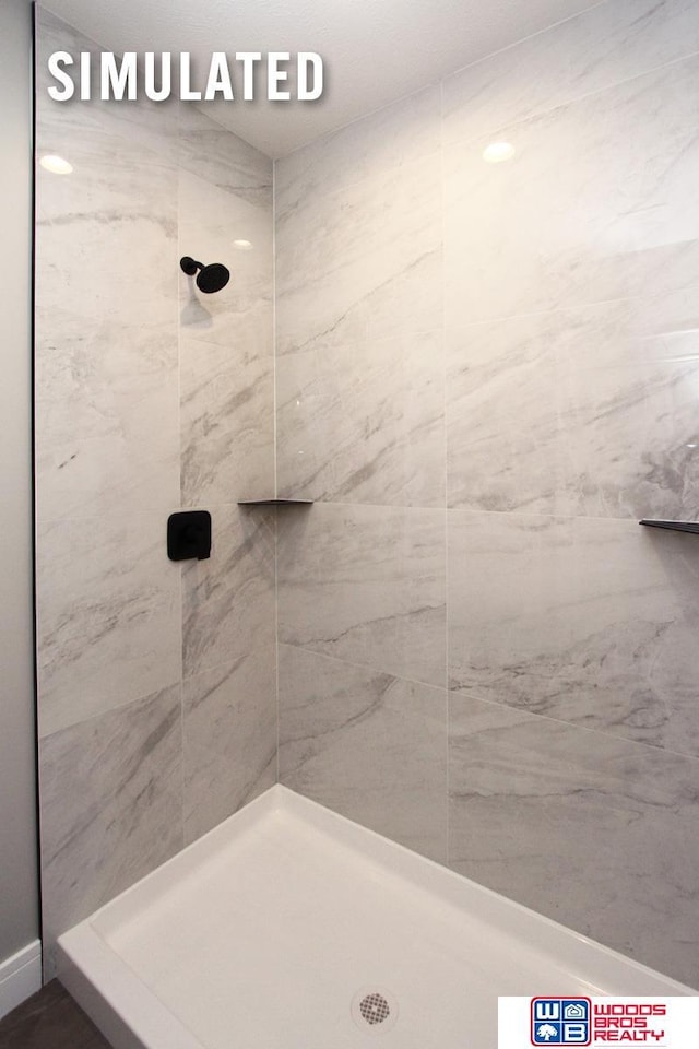 full bathroom featuring tiled shower