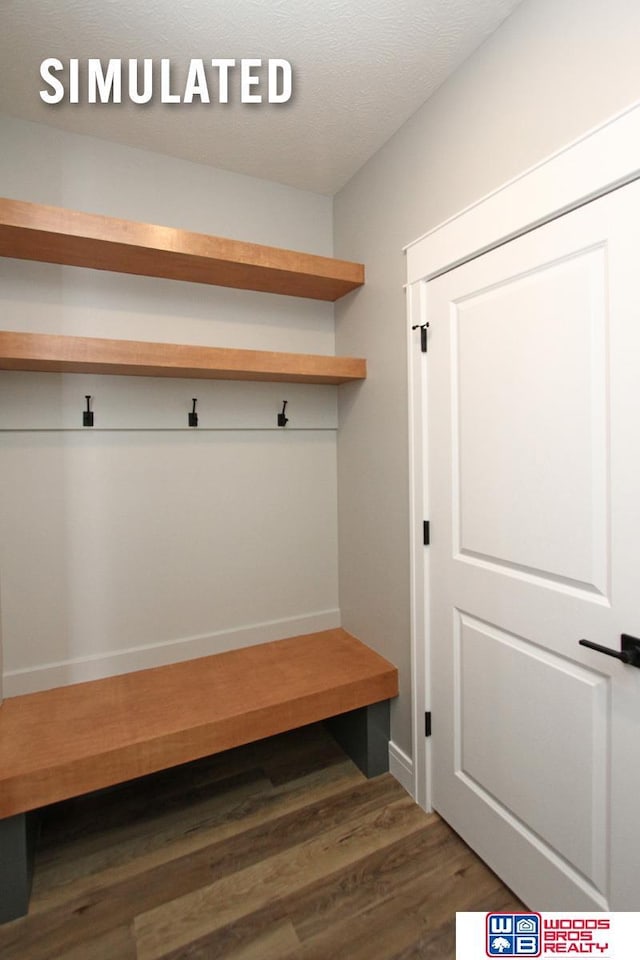 mudroom featuring wood finished floors and a textured ceiling