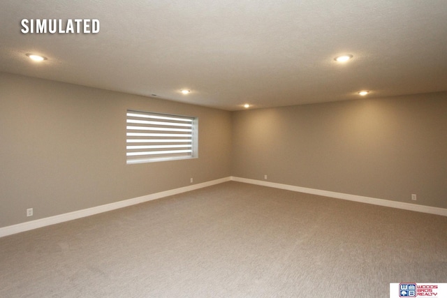 carpeted empty room with recessed lighting and baseboards