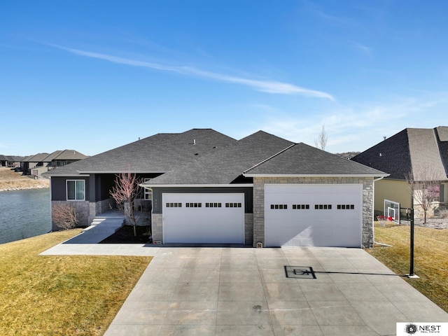 view of front facade with a garage, driveway, stone siding, and a front yard