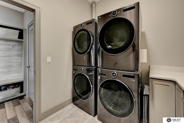 laundry room with stacked washer and dryer and cabinet space