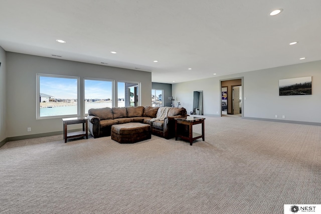 living room with light carpet, baseboards, and recessed lighting