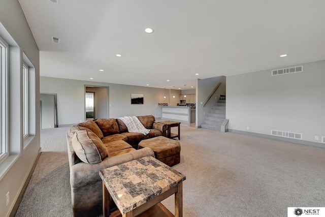 living room with recessed lighting, visible vents, and stairway