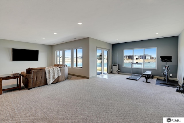 living area featuring baseboards, light colored carpet, and recessed lighting