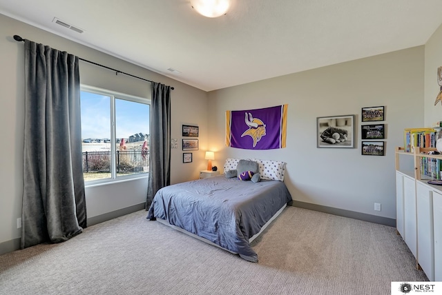 bedroom with carpet flooring, visible vents, and baseboards