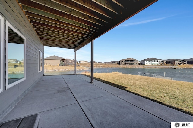 view of patio featuring a water view and a residential view